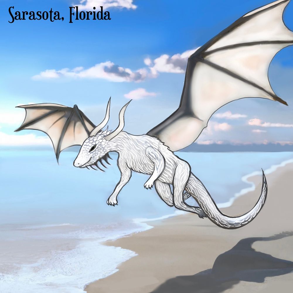 A white winged dragon flies low over a beach with the ocean and clouds behind it.